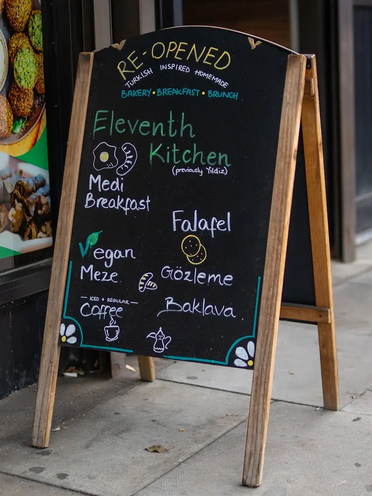 Chalkboard listing Medi Breakfast, falafel, vegan meze, gözleme and baklava